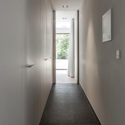 Gang met maatwerkkasten en geïntegreerde toegang tot de kelderverdieping